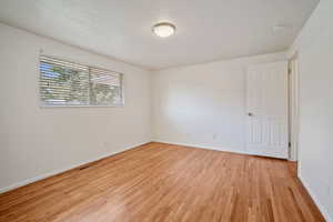 Unfurnished room with light hardwood / wood-style flooring