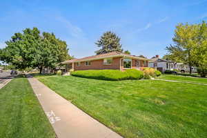 Ranch-style house featuring a front lawn