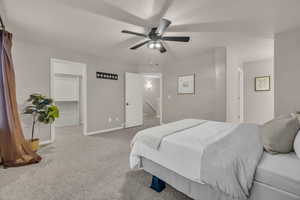 Bedroom featuring carpet floors, ceiling fan, and a spacious closet