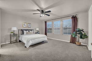 Bedroom with a textured ceiling, carpet floors, and ceiling fan