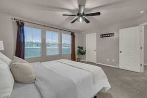 Carpeted bedroom with ceiling fan and a textured ceiling