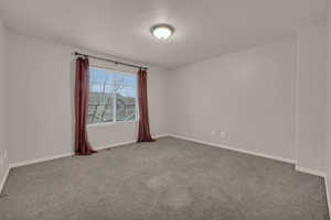 Spare room featuring carpet flooring and a textured ceiling