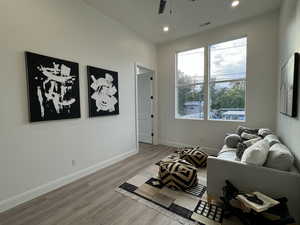 Sitting room with ceiling fan and light hardwood / wood-style flooring