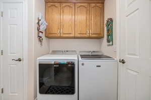 Clothes washing area with cabinets and washing machine and clothes dryer