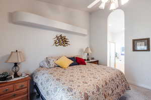 Carpeted bedroom with ceiling fan