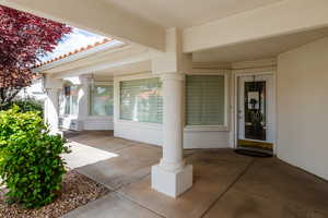 Doorway to property with a patio area