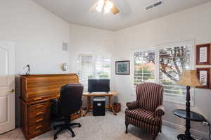 Home office featuring light colored carpet and ceiling fan