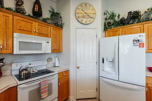 Kitchen featuring white appliances