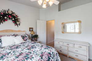 Carpeted bedroom featuring ceiling fan