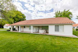 Back of property featuring a patio and a yard