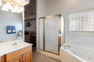 Bathroom featuring plus walk in shower and vanity