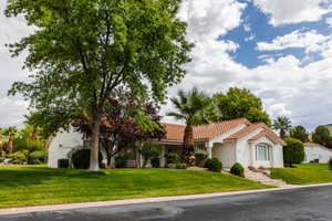 Mediterranean / spanish-style house with a front lawn