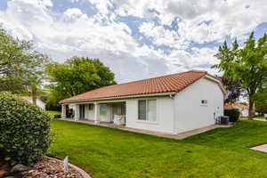 Back of house with a lawn and cooling unit