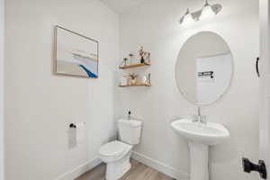 Bathroom featuring hardwood / wood-style floors and toilet