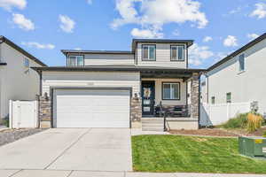 View of front of house featuring a garage and a front lawn