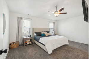 Carpeted bedroom with ceiling fan