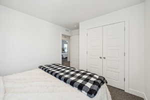 Bedroom featuring carpet floors and a closet