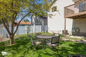 View of yard featuring a deck and central AC