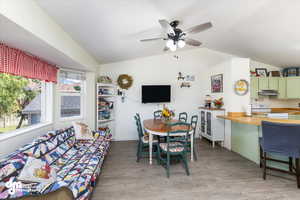 Dining area featuring light hardwood / wood-style floors, ceiling fan, and lofted ceiling