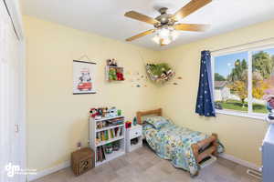 Bedroom with ceiling fan and a closet