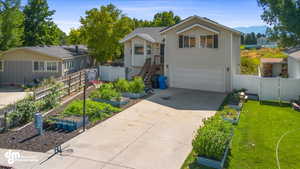 Front facade featuring a garage and a front lawn