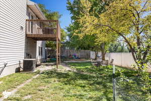 View of yard featuring central air condition unit and a deck