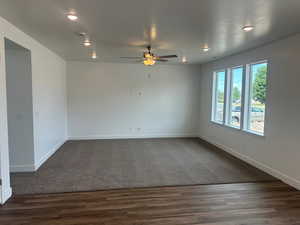 Carpeted empty room with ceiling fan