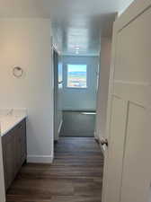 Bathroom featuring wood-type flooring, a textured ceiling, and vanity