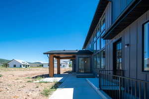 Doorway to property with a patio area and a mountain view