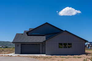 View of front of home featuring a garage and a mountain view