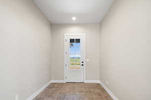 Doorway featuring light tile patterned flooring