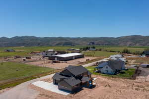 Birds eye view of property featuring a mountain view and a rural view