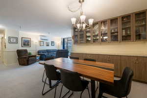 Dining area with built-in quarts top serving counter and glass front cabinet, with lots of storage space below..