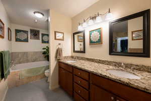 En-suite bath with double vanity and granite countertops