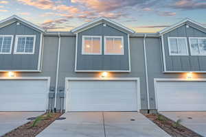 Townhome / multi-family property featuring a garage