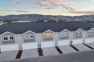 View of front of house featuring a mountain view and a garage