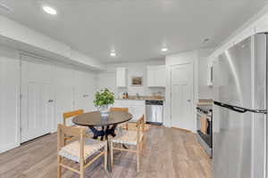 Dining room with light wood-type flooring and sink