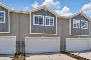 Townhome / multi-family property featuring a garage