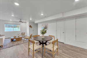 Dining room with light hardwood / wood-style flooring and ceiling fan