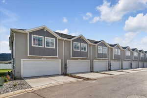 Townhome / multi-family property featuring a garage