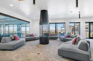 Living room with carpet flooring and a wealth of natural light