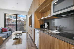 Kitchen with dark wood-type flooring, stainless steel appliances, and sink