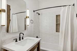 Bathroom featuring vanity and shower / bath combo with shower curtain