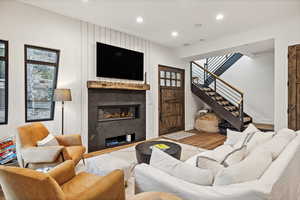 Living room featuring hardwood / wood-style floors and a large fireplace