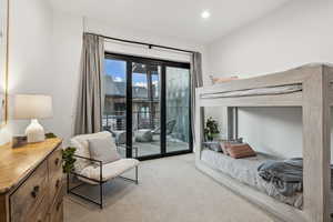 Bedroom featuring light carpet and access to outside