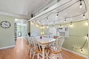 Dining space featuring light hardwood / wood-style flooring and cooling unit