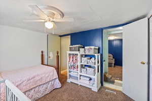 Carpeted bedroom with ceiling fan