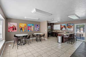 Tiled dining area with a textured ceiling