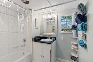 Bathroom with vanity and shower / tub combo with curtain