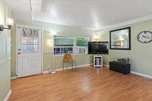 Entryway featuring cooling unit, a wealth of natural light, and light hardwood / wood-style floors